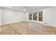 A spacious main bedroom with light wood flooring and large windows overlooking a treed lot at 5548 Martina Way, Atlanta, GA 30338