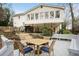 Backyard area features a deck, covered patio, landscaping, and stairs up to the back of the home at 295 Bruton Way, Atlanta, GA 30342