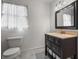 Cozy bathroom with a dark wooden vanity, marble floors, and soft lighting at 295 Bruton Way, Atlanta, GA 30342