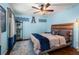 Light blue bedroom with hardwood floors, a ceiling fan, and collegiate decor at 295 Bruton Way, Atlanta, GA 30342