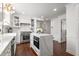 Bright white kitchen boasts stainless steel appliances, marble counters and an island with a built-in oven at 295 Bruton Way, Atlanta, GA 30342