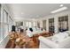 Bright living room filled with natural light, white sofas, and unique wood accent pieces at 295 Bruton Way, Atlanta, GA 30342