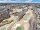 Expansive aerial view of a neighborhood featuring a golf course and pond at 601 Wyndham Ct, Canton, GA 30115