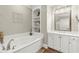 Bathroom featuring a large soaking tub with built-in shelving and storage space at 8730 Parker Pl, Roswell, GA 30076