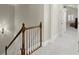 Hallway with wood and white banister leading to bedrooms and bathrooms at 8730 Parker Pl, Roswell, GA 30076