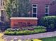 Signage for 'Towns of Crescent Park' amidst landscaped flower beds at 2482 Crescent Park Ct, Atlanta, GA 30339