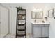 Bright bathroom with a sleek vanity, glass shower, and stylish decorative storage at 569 Stone Field Nw Run, Marietta, GA 30060
