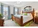 Comfortable bedroom featuring a wooden bed frame, white bedding, and natural light at 569 Stone Field Nw Run, Marietta, GA 30060