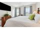 Bright bedroom featuring a bed with white comforter, and matching curtains at 569 Stone Field Nw Run, Marietta, GA 30060