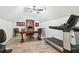 Versatile bonus room with vaulted ceilings, equipped with a treadmill, desk, and exercise bike at 569 Stone Field Nw Run, Marietta, GA 30060