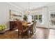 Bright dining room features hardwood floors, natural light, sideboard and door to patio at 569 Stone Field Nw Run, Marietta, GA 30060