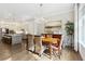 Open view from dining room to kitchen and island with seating at 569 Stone Field Nw Run, Marietta, GA 30060