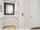 Home elevator with wood paneling, wood floors and mirror at 569 Stone Field Nw Run, Marietta, GA 30060