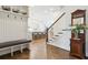 Spacious entryway with a built-in bench, open staircase, and view of the modern kitchen at 569 Stone Field Nw Run, Marietta, GA 30060