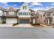 Beautiful townhome exterior featuring stone accents, a gray garage door, and a paved driveway at 569 Stone Field Nw Run, Marietta, GA 30060