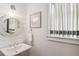 Charming half bath features shiplap walls, decorative mirror, faucet and light fixture at 569 Stone Field Nw Run, Marietta, GA 30060