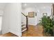 Upstairs hallway with hardwood floors, white walls, staircase, and plant at 569 Stone Field Nw Run, Marietta, GA 30060