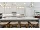 Elegant kitchen island with seating and stylish pendant lights, complemented by hardwood floors at 569 Stone Field Nw Run, Marietta, GA 30060