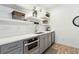 Modern kitchenette features sleek cabinets, open shelving, and stainless steel appliances at 569 Stone Field Nw Run, Marietta, GA 30060