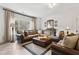 Cozy living room showcasing a large sectional, decor, and natural light from a large window at 569 Stone Field Nw Run, Marietta, GA 30060