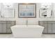 Upscale bathroom with dual vanities, a tub, and modern fixtures at 569 Stone Field Nw Run, Marietta, GA 30060