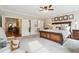 Large bedroom with a sitting area, luxury furniture, and natural light at 569 Stone Field Nw Run, Marietta, GA 30060