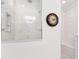 Modern shower with glass door and marble tile surround at 569 Stone Field Nw Run, Marietta, GA 30060