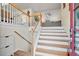 Welcoming entryway featuring a staircase, hardwood floors, and a glimpse into the living area at 1100 Bradford Park Dr, Auburn, GA 30011