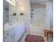 Bright bathroom with a shower-tub combo, white cabinets, a large mirror, and a jacuzzi tub at 3831 Austin Park Ln, Decatur, GA 30032