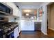 Well lit kitchen features updated appliances, white cabinets, stainless steel microwave, and dark hardwood floors at 3831 Austin Park Ln, Decatur, GA 30032