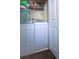 Functional laundry room with washer, dryer, wire shelf, and dark hardwood floors at 3831 Austin Park Ln, Decatur, GA 30032