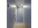 Carpeted stairwell with light blue walls, white handrail, and a thermostat at 3831 Austin Park Ln, Decatur, GA 30032