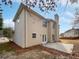 Back exterior featuring vinyl siding, chimney, brick patio and fenced yard at 730 Taylor School Dr, Lawrenceville, GA 30043