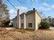 Back exterior featuring vinyl siding, chimney, brick patio and fenced yard at 730 Taylor School Dr, Lawrenceville, GA 30043