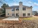 Back exterior featuring vinyl siding, chimney, brick patio and fenced yard at 730 Taylor School Dr, Lawrenceville, GA 30043
