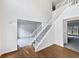 Inviting entryway with hardwood floors, staircase with white railings, and views into adjacent rooms at 730 Taylor School Dr, Lawrenceville, GA 30043