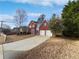 Traditional home with red brick, blue shutters, a blue front door, and a long driveway at 730 Taylor School Dr, Lawrenceville, GA 30043