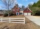 Charming two-story home with a combination brick and siding exterior and white two-car garage doors at 730 Taylor School Dr, Lawrenceville, GA 30043