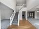 Spacious two-story foyer with hardwood floors, a staircase, and views into other rooms at 730 Taylor School Dr, Lawrenceville, GA 30043