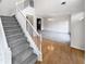 Bright foyer with staircase and hardwood floors leading to formal dining room at 730 Taylor School Dr, Lawrenceville, GA 30043