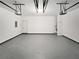 Spacious two-car garage featuring durable flooring, and ample overhead lighting for convenience at 730 Taylor School Dr, Lawrenceville, GA 30043