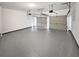 Clean garage with sealed concrete floor and two garage doors at 730 Taylor School Dr, Lawrenceville, GA 30043