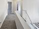 Upstairs hallway with neutral carpet and white banister leading to bedrooms at 730 Taylor School Dr, Lawrenceville, GA 30043