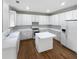 Clean white kitchen with updated appliances and central island at 730 Taylor School Dr, Lawrenceville, GA 30043