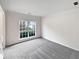 Bright living room with fresh gray carpet and a large window with great light at 730 Taylor School Dr, Lawrenceville, GA 30043