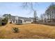 This spacious backyard includes a privacy fence, mature trees, and lush lawn at 1135 Chandler Ridge Dr, Lawrenceville, GA 30045