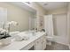 This bathroom features a white vanity, framed mirror, and shower with tub at 1135 Chandler Ridge Dr, Lawrenceville, GA 30045