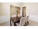 Cozy dining room with a dark wood table, light-colored chairs, and wainscoting, perfect for Gathering gatherings at 1135 Chandler Ridge Dr, Lawrenceville, GA 30045