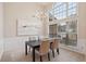 Bright dining area featuring a chandelier, large windows, and neutral decor perfect for entertaining guests at 1135 Chandler Ridge Dr, Lawrenceville, GA 30045