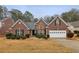 Charming brick home featuring a well-manicured lawn and attached garage, perfect for suburban living at 1135 Chandler Ridge Dr, Lawrenceville, GA 30045